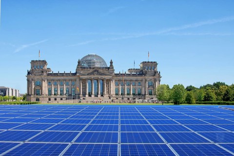 Symbolic image, solar park in the city, Reichstag building Berlin with modules on the green area,