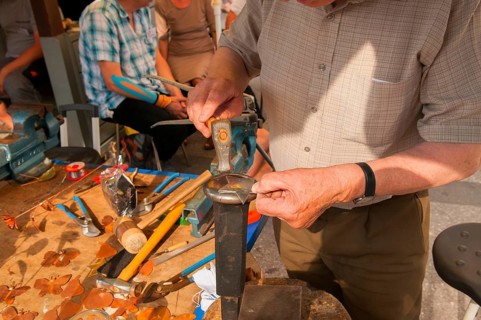 Tinsmith at work, old trade, tinsmiths or plumbers are craftsmen who take care of metal products.