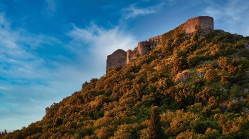 Byzantine castle from the 13th century AD, Ancient walls towering over a green, overgrown slope