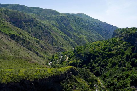 Deep gorge with dense green vegetation and wooded slopes under a clear sky, Garni Gorge, Azat