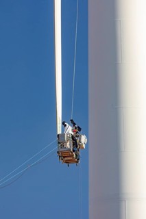 Luverne, Minnesota - Workers repair the cracked blade of a wind turbine