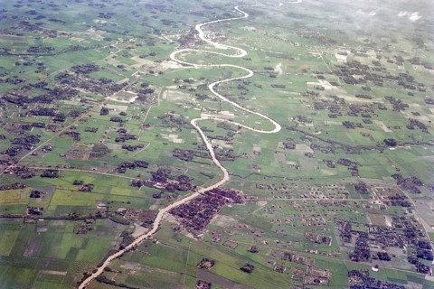 Captioned as 'aerial photo Saigon', meandering river in flat agricultural landscape of paddy