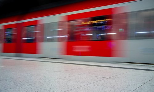 Underground arriving S-Bahn, train, class 420 in traffic red, platform, stop, station city centre,