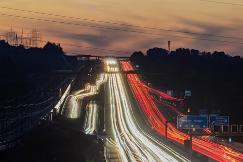 Motorway near Stuttgart with several lanes in the evening with sunset. Heavy traffic with light