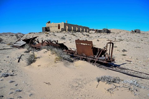 Wagon of an old narrow-gauge railway in the desert sand, Pomona, restricted diamond area, near