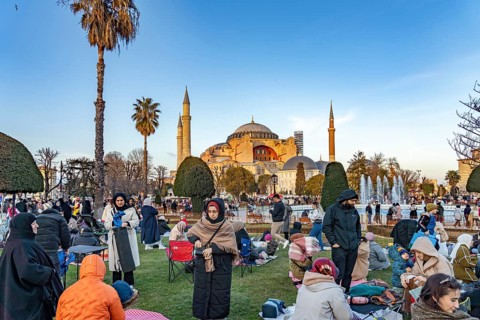 Muslims at an evening Ramadan picnic in the park in front of the Hagia Sophia mosque in Istanbul,