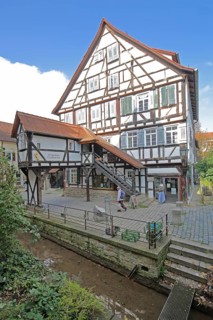 Historic nun's house built in 1488 with staircase by the stream, Ammer Canal, half-timbered house,