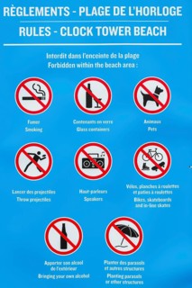 Posted rules sign with pictograms showing various restrictions at Clock Tower Beach, Old Port of