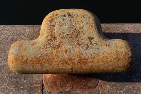 Close-up of bollard with flaking paint and rust spots on King Edward pier in Old Port of Montreal,