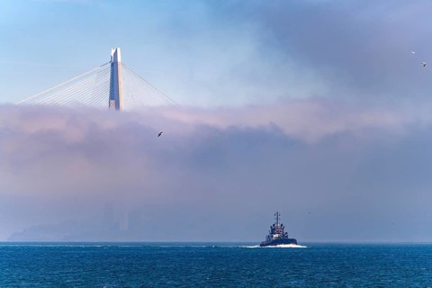 Coast Guard boat on the Bosphorus in front of the Yavuz Sultan Selim Bridge in the fog near