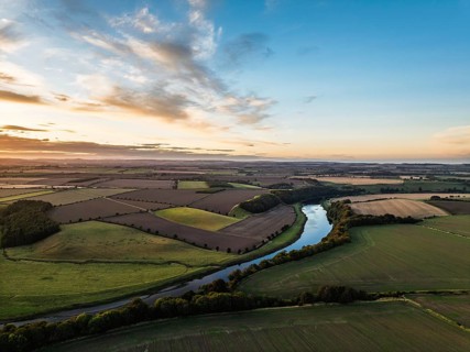 Sunset of Farms and Fields over Norham Castle from a drone, Norham, River Tweed, Northumberland,