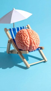 Brain relaxes on a sunbed under the summer sun, placed on a flat surface, symbol for mental health,