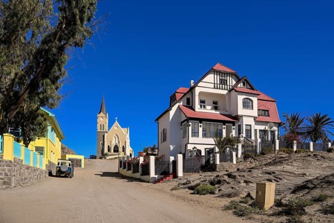 Colonial house facade in the Kirchstraße, in the background the rock church, Lüderitz, Karas