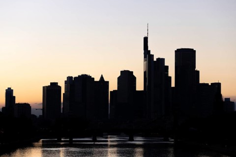 The silhouette of Frankfurt's banking skyline stands out against the backlight of the evening sun,