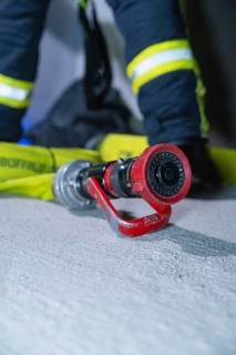 Close-up of a fire hose on the ground, ready for action, fire drill in the new construction tunnel
