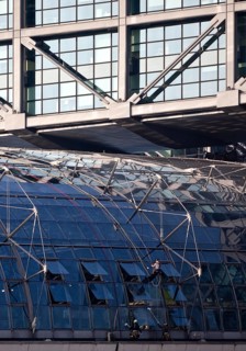 Three male glass cleaners cleaning a glass roof at Berlin Central Station, Berlin, Germany