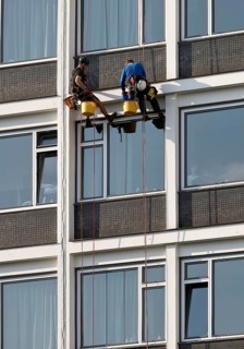 Two male glass cleaners abseiling down the hotel façade to clean windows, aletto Hotel Kudamm,