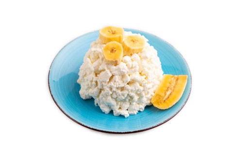 White ?ottage cheese, Curd, with Banana isolated on white background, side view, close up