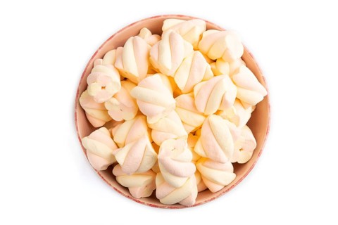 Orange and pink marshmallow in ceramic bowl isolated on white background, top view, flat lay, copy