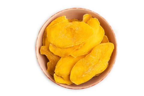 Dried Mango in ceramic bowl isolated on white background. Top view, close up, flat lay. healthy