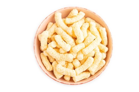 Corn flakes sticks with caramel in ceramic bowl isolated on white background. top view, flat lay,