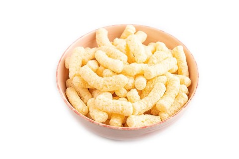 Corn flakes sticks with caramel in ceramic bowl isolated on white background. Side view, close up