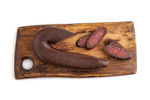 Sujuk sausage isolated on wooden cutting board on white background. Top view, flat lay, copy space