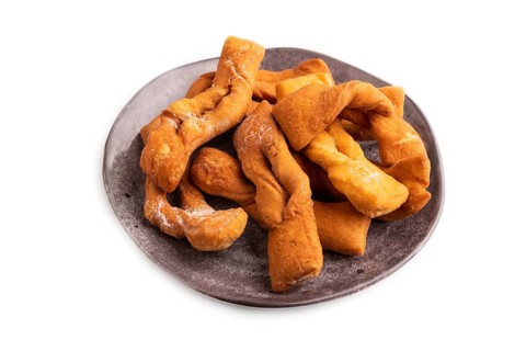 Crunchy biscuit Brushwood cookies sprinkled with powdered sugar isolated on white background, side
