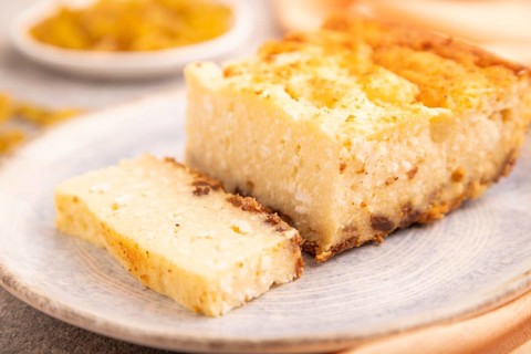 ?ottage cheese ?asserole, Curd cake, with dried apricots and raisins on brown concrete background