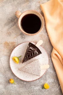 Chocolate and Vanilla Cake pops Marshmallow with cup of coffee on brown concrete background and