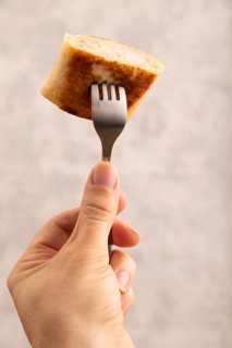 Fried crispy pancakes with meat and cheese with hand. side view, close up, selective focus