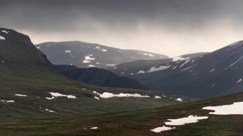 Lonely plateau with snowfields, low clouds, Kongevegen or King's Road, Olavsleden pilgrimage route,