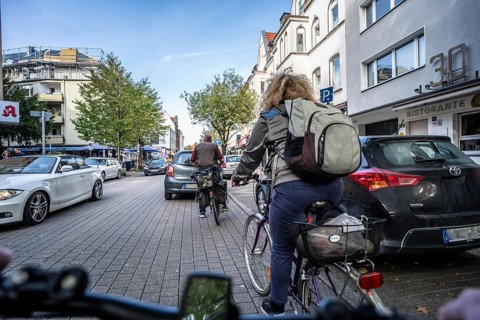 Cycling in the city, city centre road, cycle lane, two-wheeled traffic has priority, 30 km/h zone,