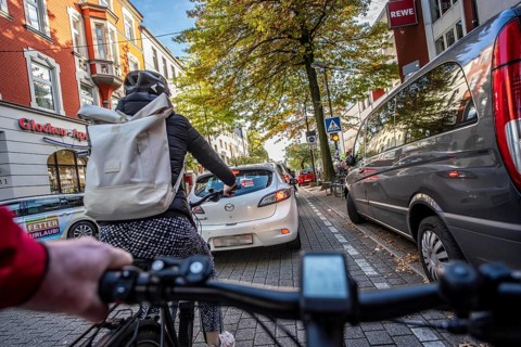 Cycling in the city, city centre road, cycle lane, two-wheeled traffic has priority, 30 km/h zone,