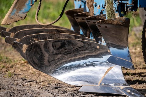 Plough, for ploughing a field, field, ploughshares, agricultural technology, shiny stainless steel,