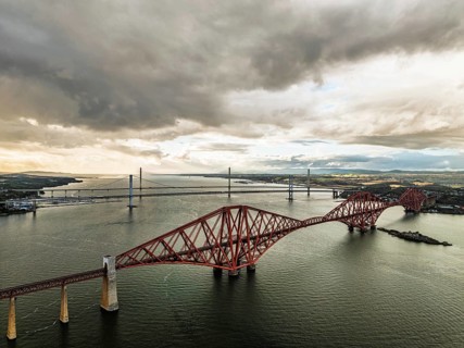 Rain clouds over Forth Bridge from a drone, Queensferry Crossing, Forth Estuary, Scotland, United