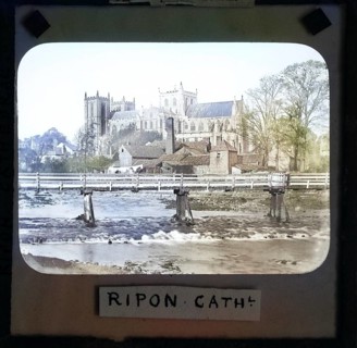 Colorised magic lantern slide of Ripon cathedral church from River Ure, Ripon, North Yorkshire,