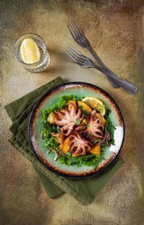 Warm salad, grilled mini octopus, with potatoes and fresh herbs, homemade, no people