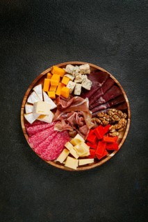 Assortment of cheese meat cuts, on a plate, top view, no people