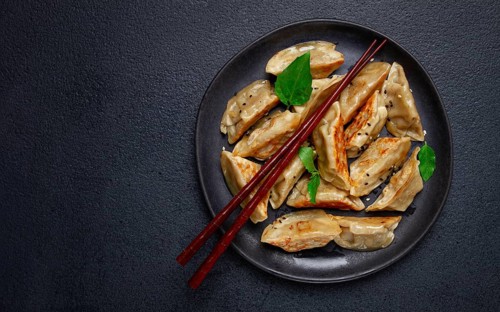 Japanese fried gyoza dumplings, with pork, sesame seeds, green onions