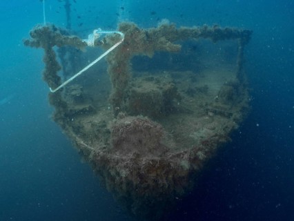 Bow of a shipwreck with rope and algae in blue water. Dive site wreck of the Vis, Pula, Croatia,