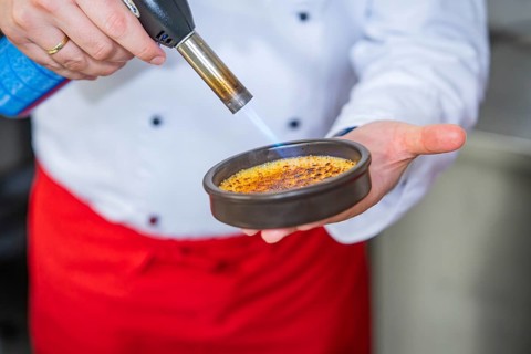 Dessert is caramelised using a Bunsen burner
