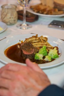 Dish with steak and vegetables on a white plate