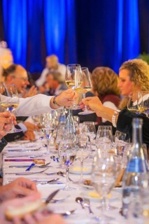 People toast with wine glasses at an elegant event
