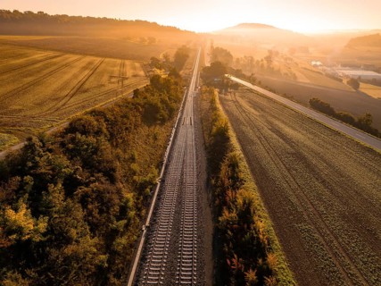 Railway tracks cutting through a rural landscape at sunrise, Hermann Hesse railway, Ostelsheim,