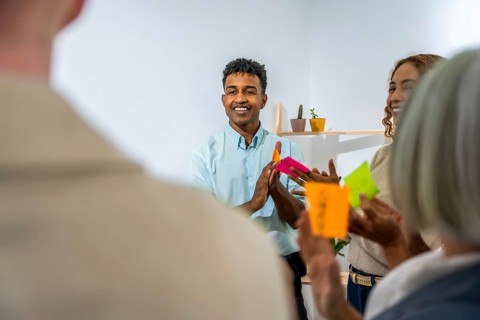 Diverse business people actively participating in a creative brainstorming session, discussing new