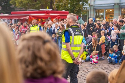 A security guard stands vigil during a well-attended event, Feuernacht, Sindelfingen, Germany