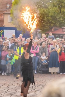 A fire show artist demonstrates her skills in front of a fascinated audience, Feuernacht,