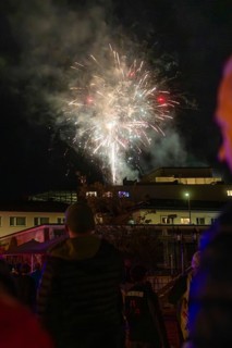 Spectacular fireworks illuminate the night sky during a celebration, people watch fascinated, Fire