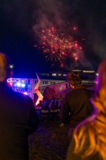 People enjoying fireworks over an illuminated outdoor event, Fire Night, Sindelfingen, Germany